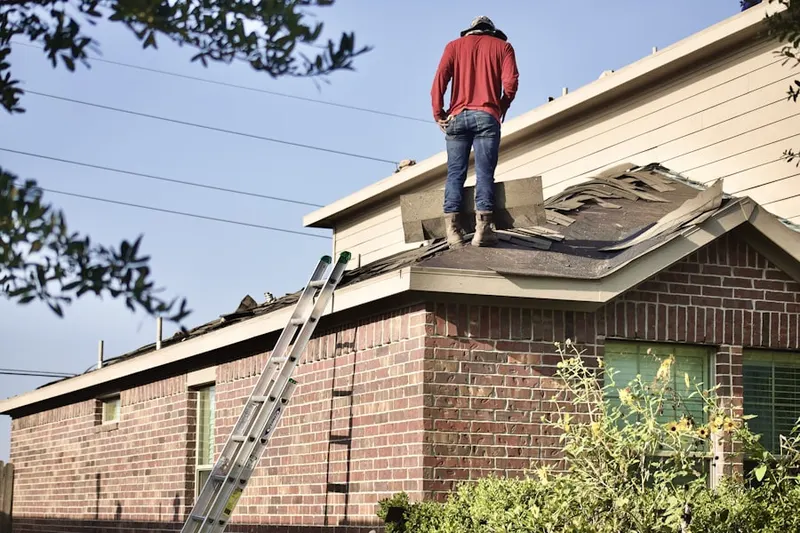 Professional roofer working on a residential roof in High Point of Delray